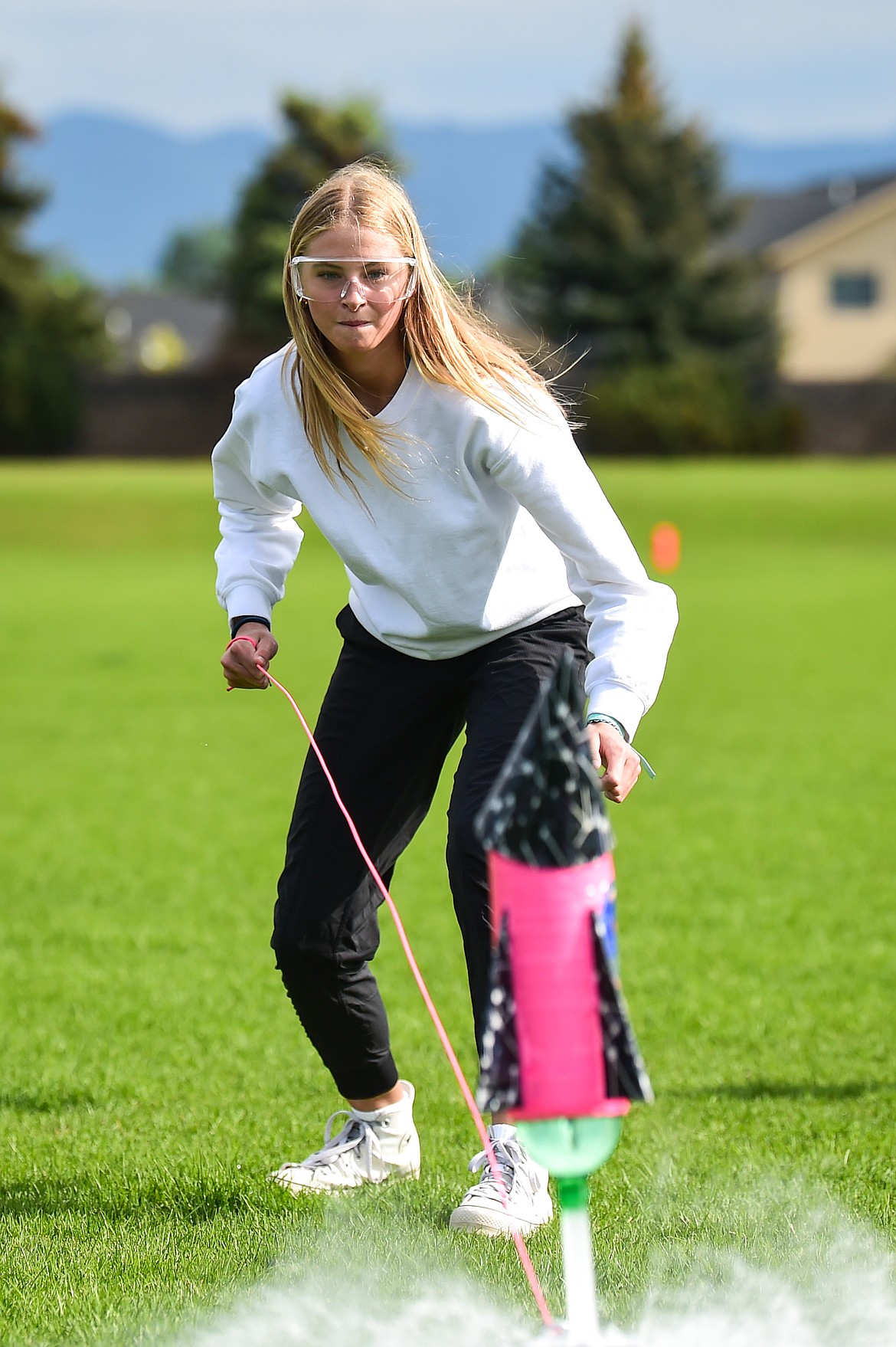 Caitlin Converse, of the Fancy Flying Flamingos team from Cayuse Prairie School, launches her team's water-powered rocket  at the Flathead Valley Rocket Rally outside Glacier High School on Thursday, May 25. On the team with Converse was Gracie Mae Kilmer and Mikayla King. (Casey Kreider/Daily Inter Lake)