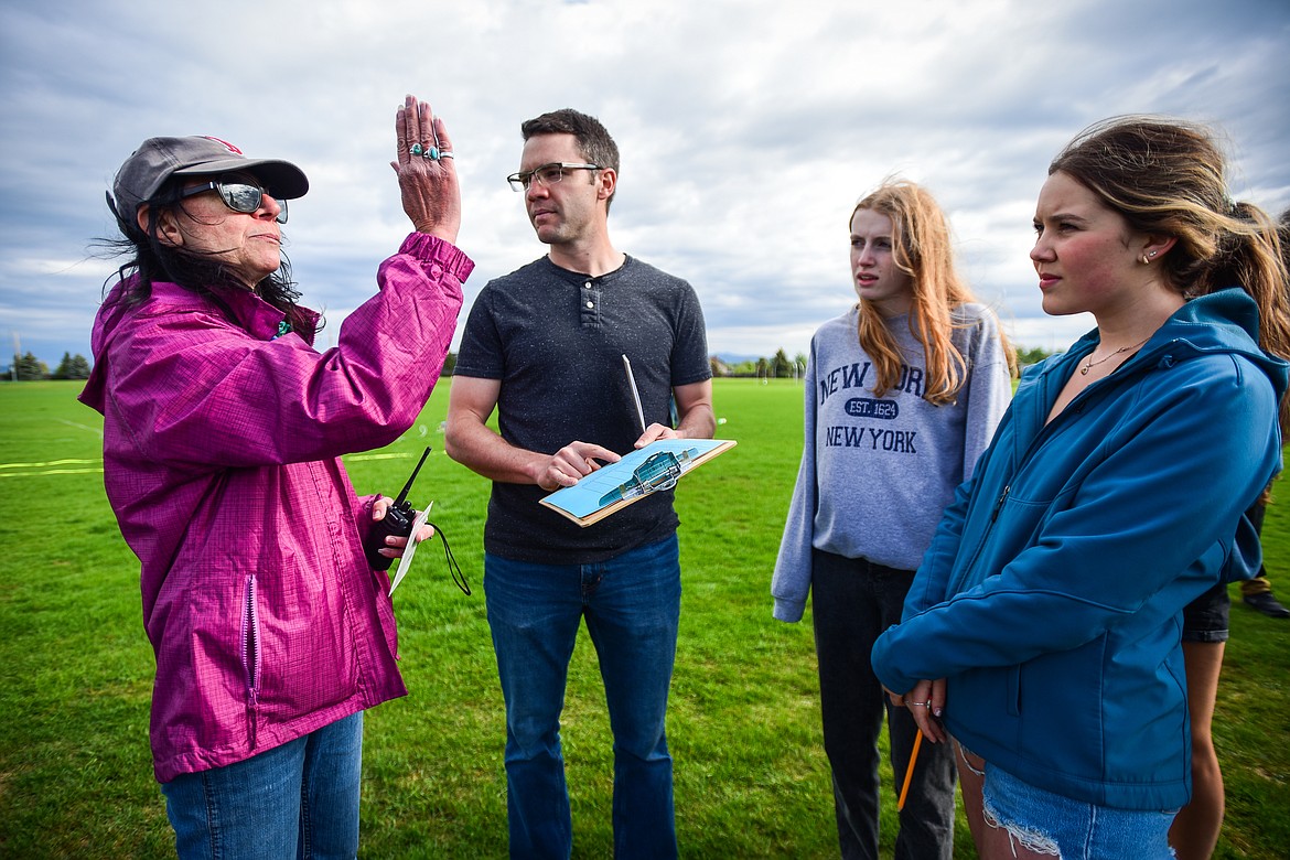Alison Godfrey describes the flight of the rockets with Glacier High School physics teacher Austin Robbins and other judges before the start of the Flathead Valley Rocket Rally on Thursday, May 25. (Casey Kreider/Daily Inter Lake)