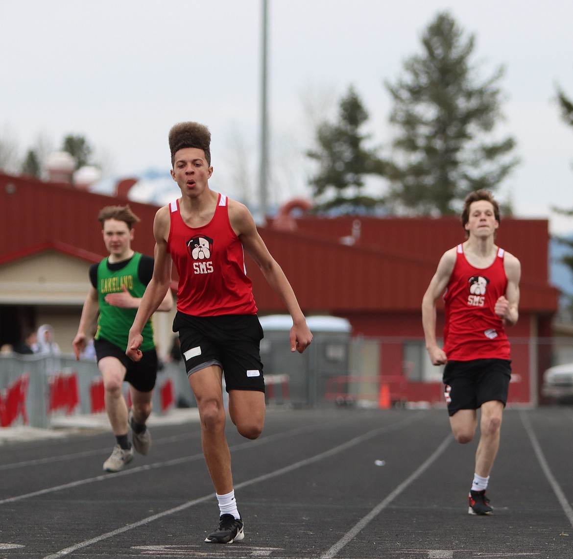From left, Trey Blumenberg and Landon Brinkmeier get ready to cross the line for Sandpoint in the 100-meter dash