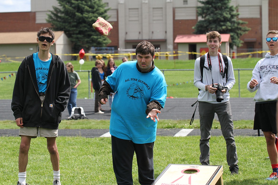 Sandpoint students watch in awe as an athlete makes a terrific throw in cornhole.