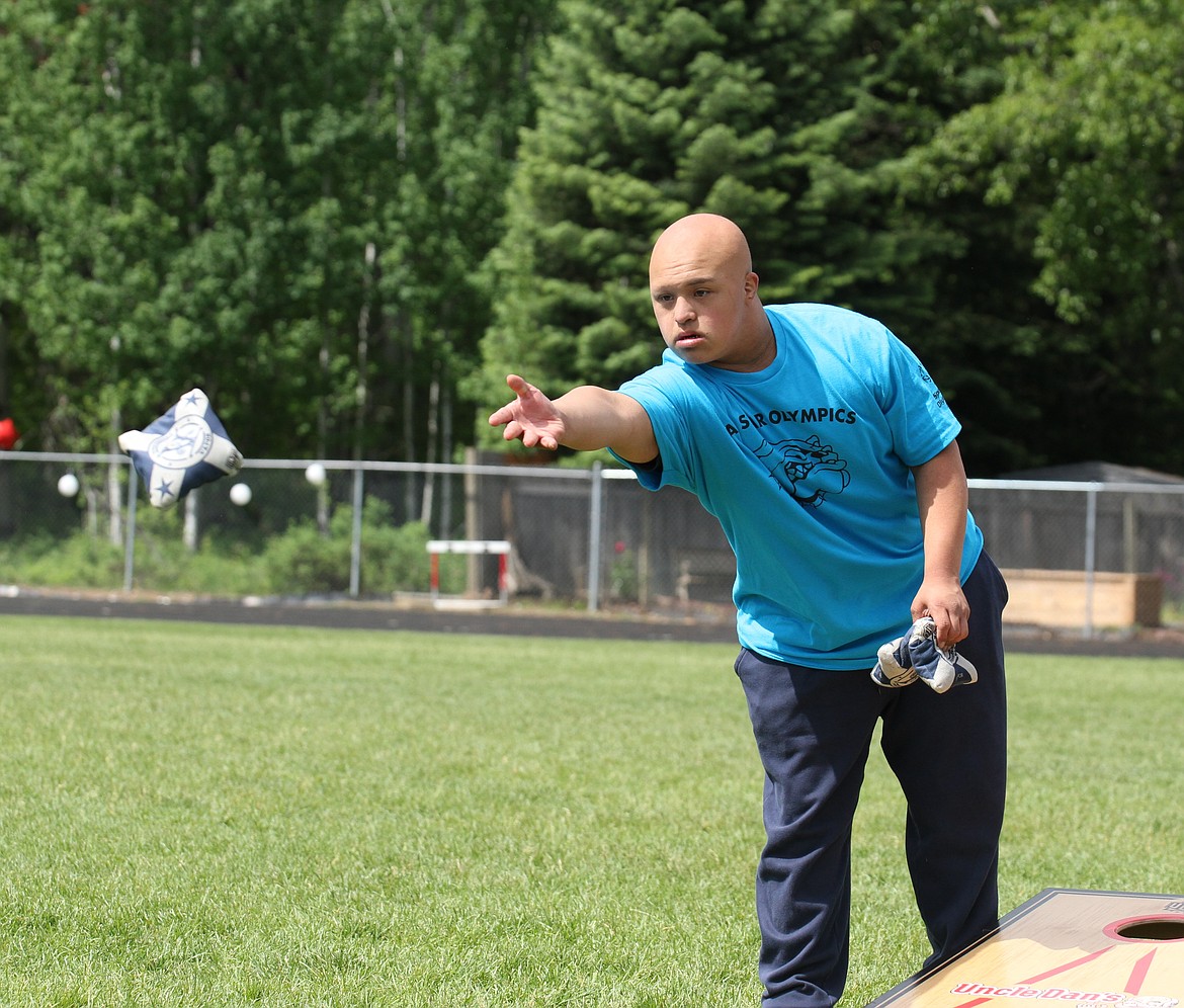 A Sandpoint athlete remains focused while throwing a bag in cornhole.