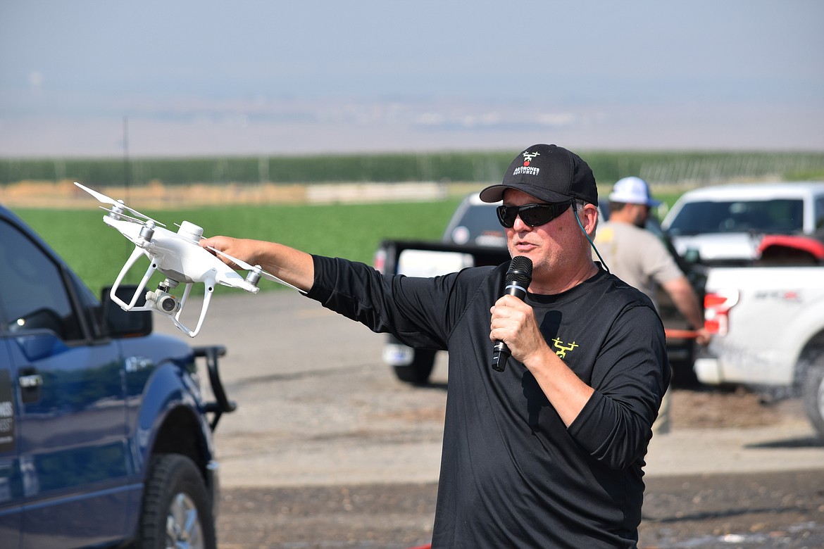 Bill Kuper, founder and chief pilot of Ag Drones Northwest, holds up a small drone used to take pictures and make measurements for maps.