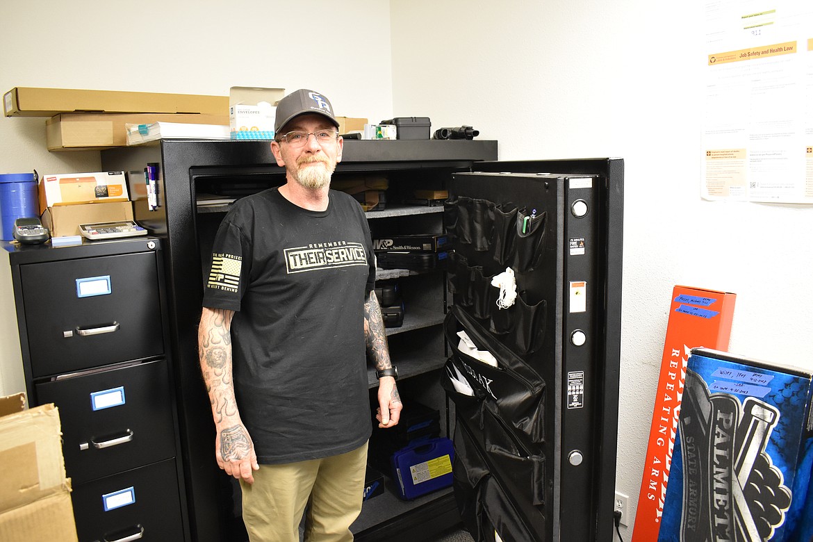 Bruce Davis, owner of Guardian Arms in Moses Lake, shows a large gun safe in the back of his store. This one uses a rotary combination lock, but PIN and thumbprint locks are also available.