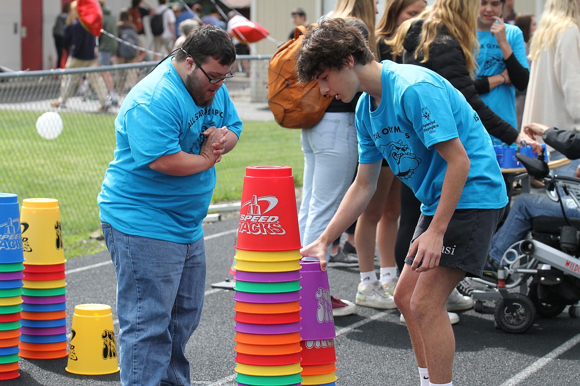 Two students get ready to start to start the speed stacking challenge.