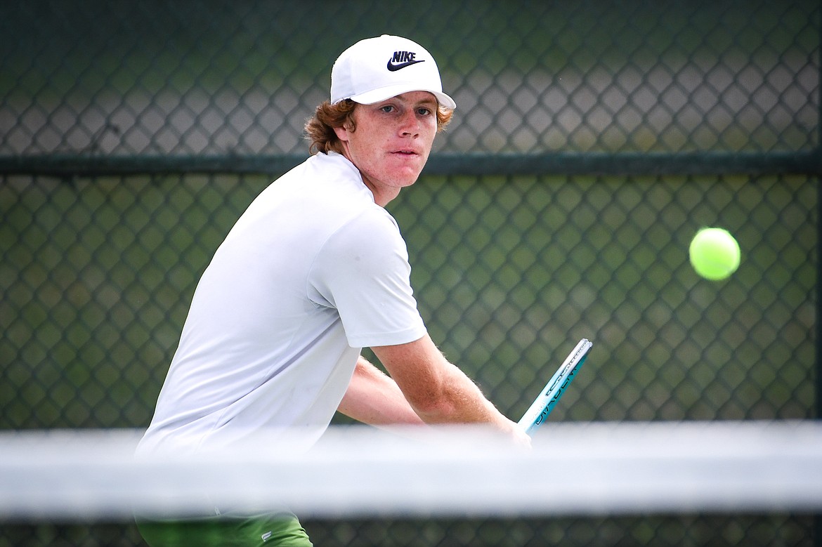 Glacier's Timmy Glanville hits a backhand return in the State AA boys doubles championship match with teammate Harrison Sanders against Gallatin's Brody Smith and Braeden Butler at Flathead Valley Community College on Friday, May 26. (Casey Kreider/Daily Inter Lake)