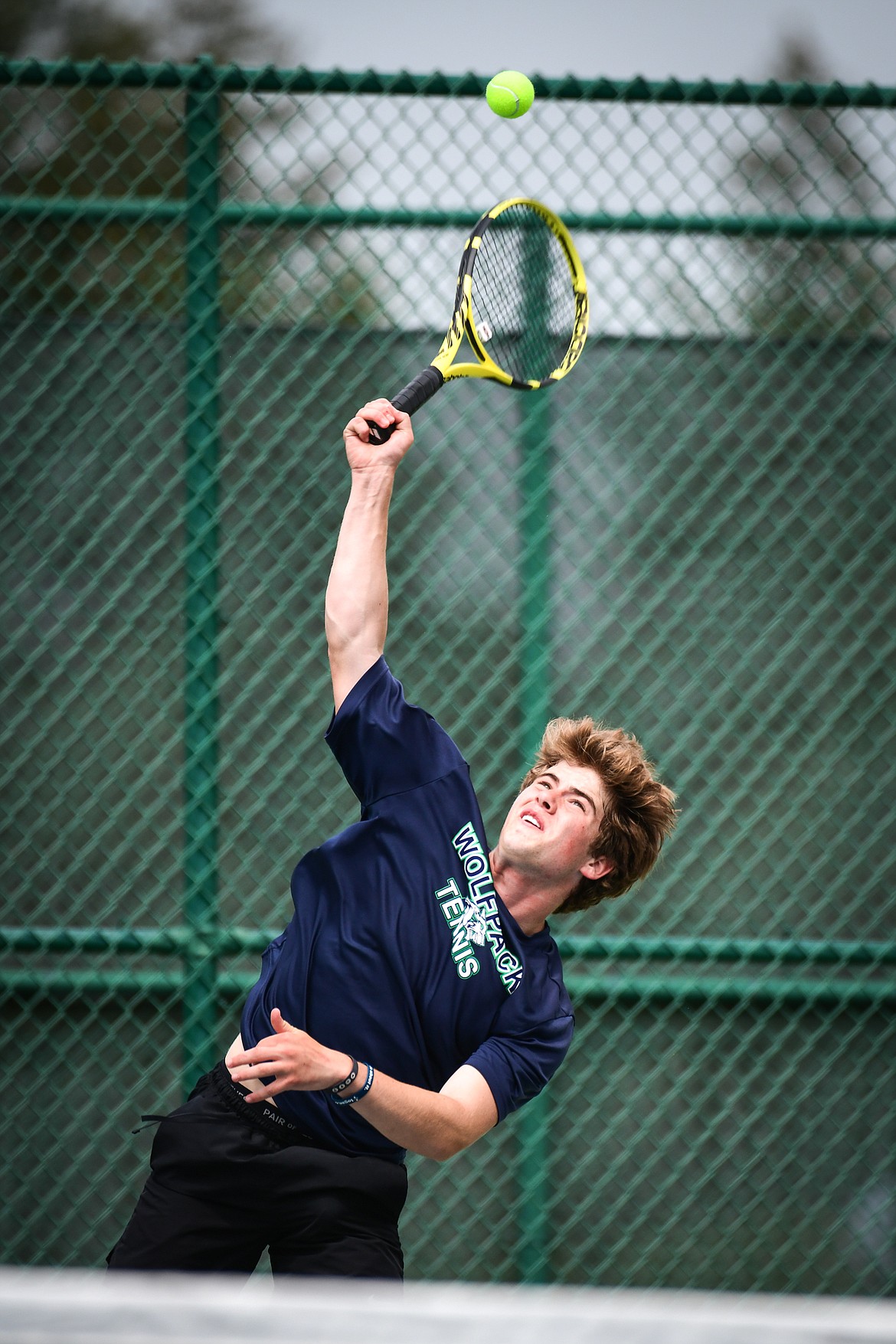 Glacier's Harrison Sanders serves in the State AA boys doubles championship match with teammate Timmy Glanville against Gallatin's Brody Smith and Braeden Butler at Flathead Valley Community College on Friday, May 26. (Casey Kreider/Daily Inter Lake)