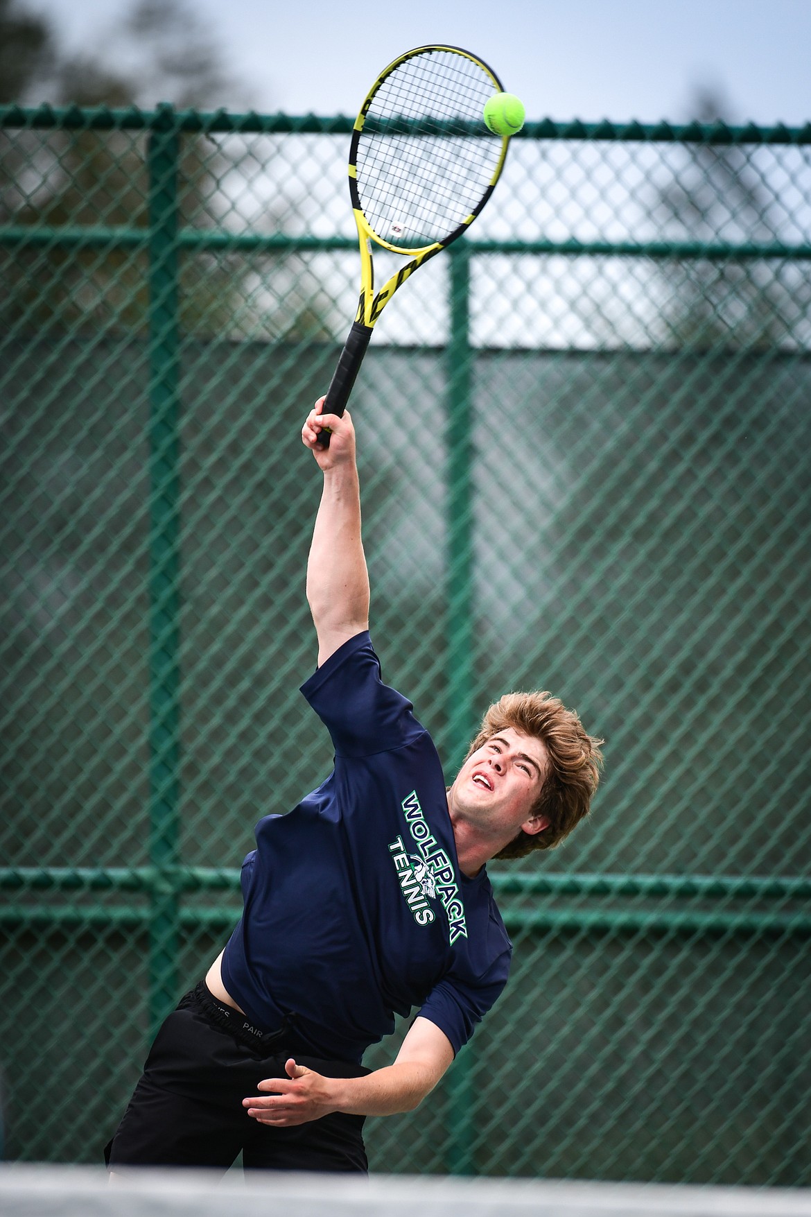 Glacier's Harrison Sanders serves in the State AA boys doubles championship match with teammate Timmy Glanville against Gallatin's Brody Smith and Braeden Butler at Flathead Valley Community College on Friday, May 26. (Casey Kreider/Daily Inter Lake)