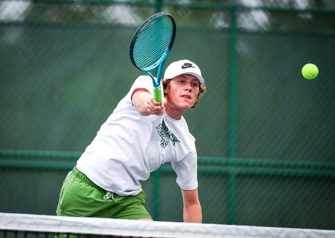 Glacier's Timmy Glanville scores a point with an overhead smash in the State AA boys doubles championship match with teammate Harrison Sanders against Gallatin's Brody Smith and Braeden Butler at Flathead Valley Community College on Friday, May 26. (Casey Kreider/Daily Inter Lake)