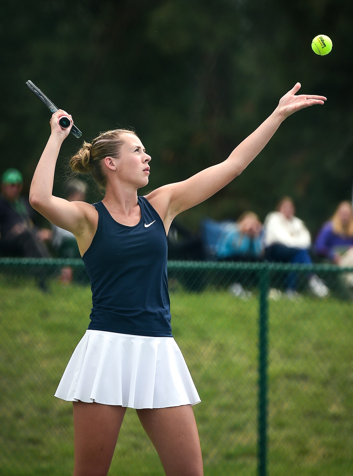 Glacier's Sarah Downs serves in the State AA girls doubles championship match with teammate Haven Speer against Missoula Hellgate's Laine Banziger and Brooke Best at Flathead Valley Community College on Friday, May 26. (Casey Kreider/Daily Inter Lake)