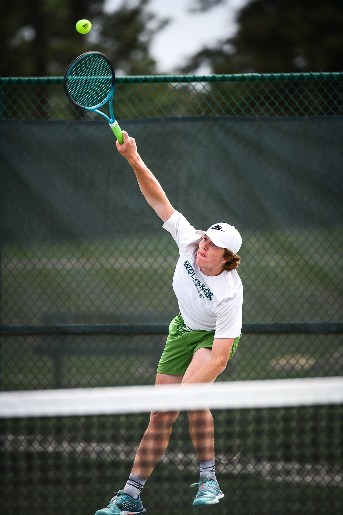 Glacier's Timmy Glanville serves in the State AA boys doubles championship match with teammate Harrison Sanders against Gallatin's Brody Smith and Braeden Butler at Flathead Valley Community College on Friday, May 26. (Casey Kreider/Daily Inter Lake)