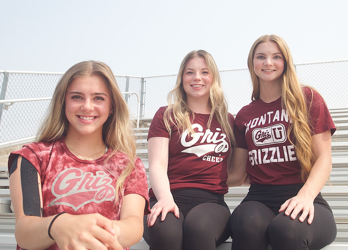 Polson High School seniors Lucy Violett, left, and Kendall Straub, right, are ready to join Polson grad Taylor Collinge, center, on the 14-member Griz Cheer Squad this fall. (Kristi Niemeyer/Lake County Leader)