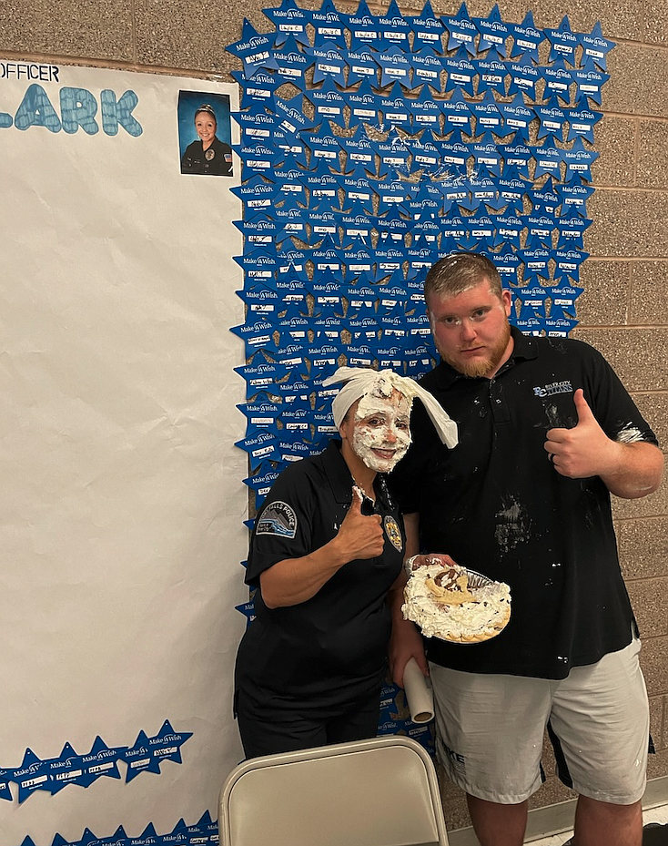 Post Falls Police Officer Annette Clark, who serves as River City Middle School's school resource officer, and River City's Safety Dean Justin Farnsworth are elated to have pie in their faces Wednesday evening after students raised $2,344 for Make-A-Wish Idaho.