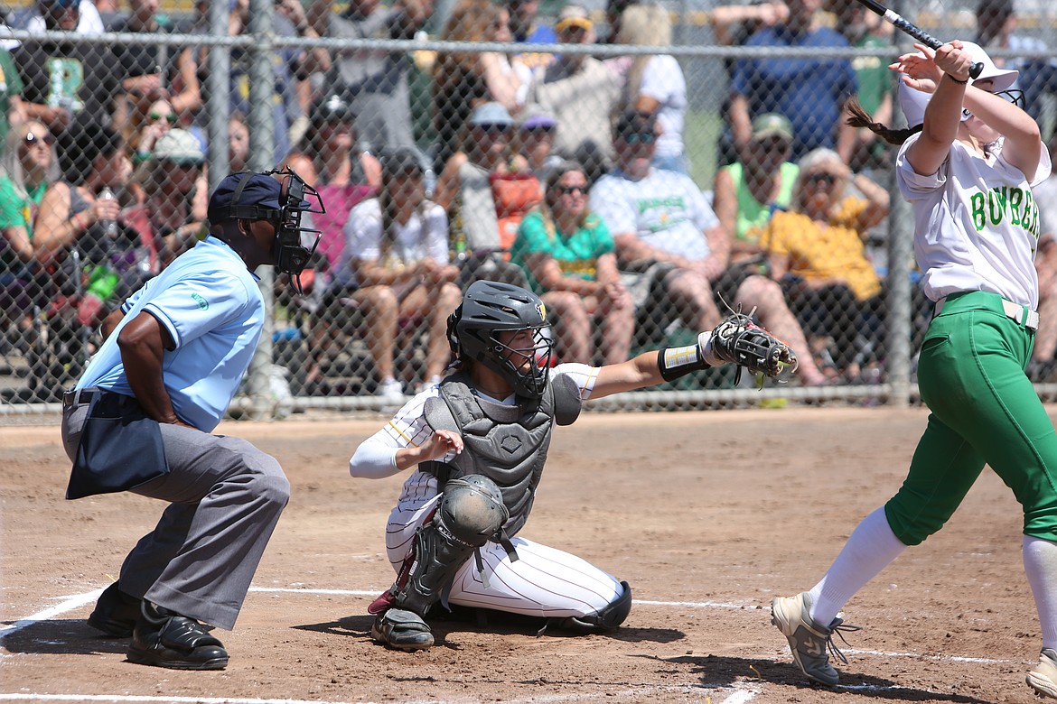 Moses Lake senior Katelyn Kriete, center, catches a pitch during the Mavs’ opening-round game of the 4A State Softball Tournament against Richland.