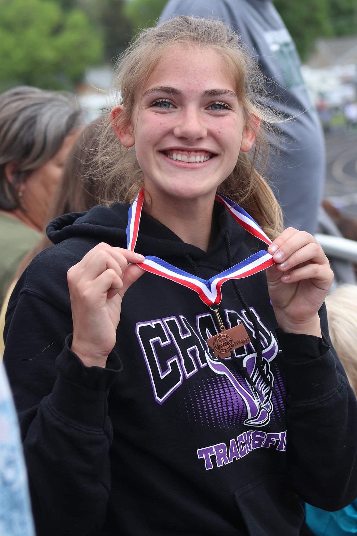 Charlo's Aida Cote shows off sixth place medals she captured in the 800 meter and the discus at the Class C state meet in Laurel. (Michelle Sharbono photo)