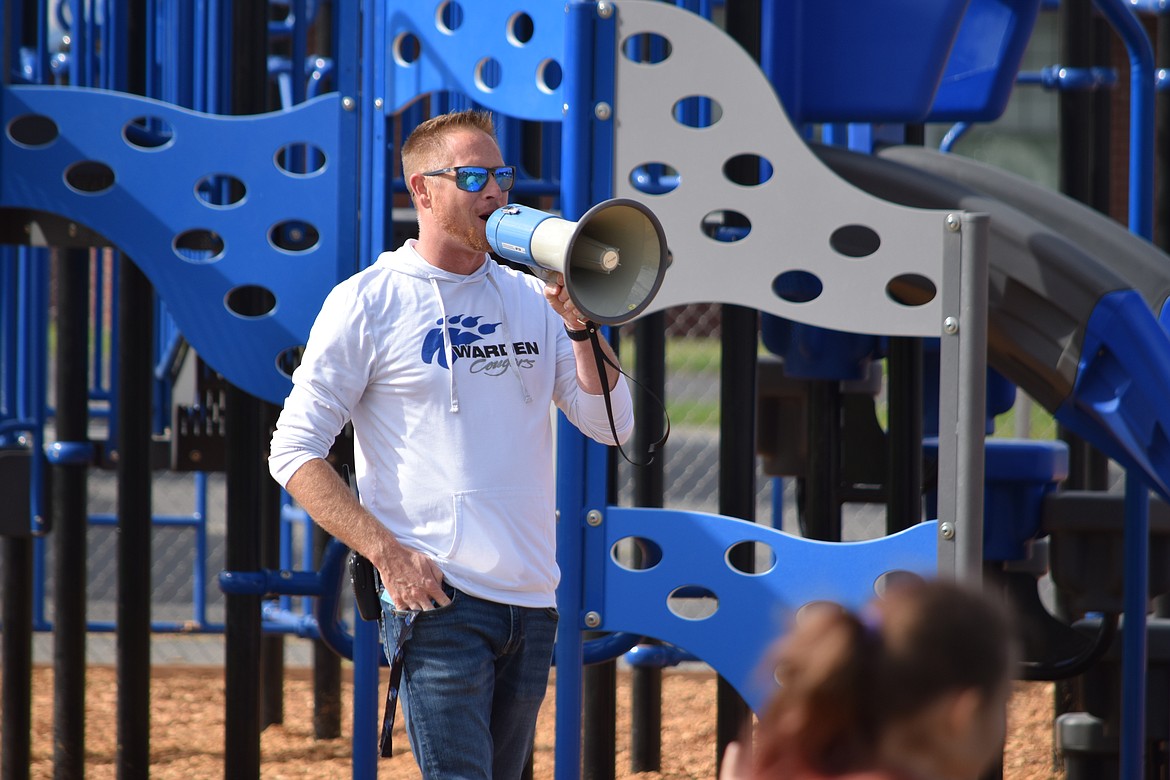 Warden Elementary School Principal Curtis Weber gives students a short briefing on the safest way to use the school’s new playground equipment. The district formally inaugurated the new playground sets, which were purchased with a $145,000 state grant, during a short ceremony Friday morning.