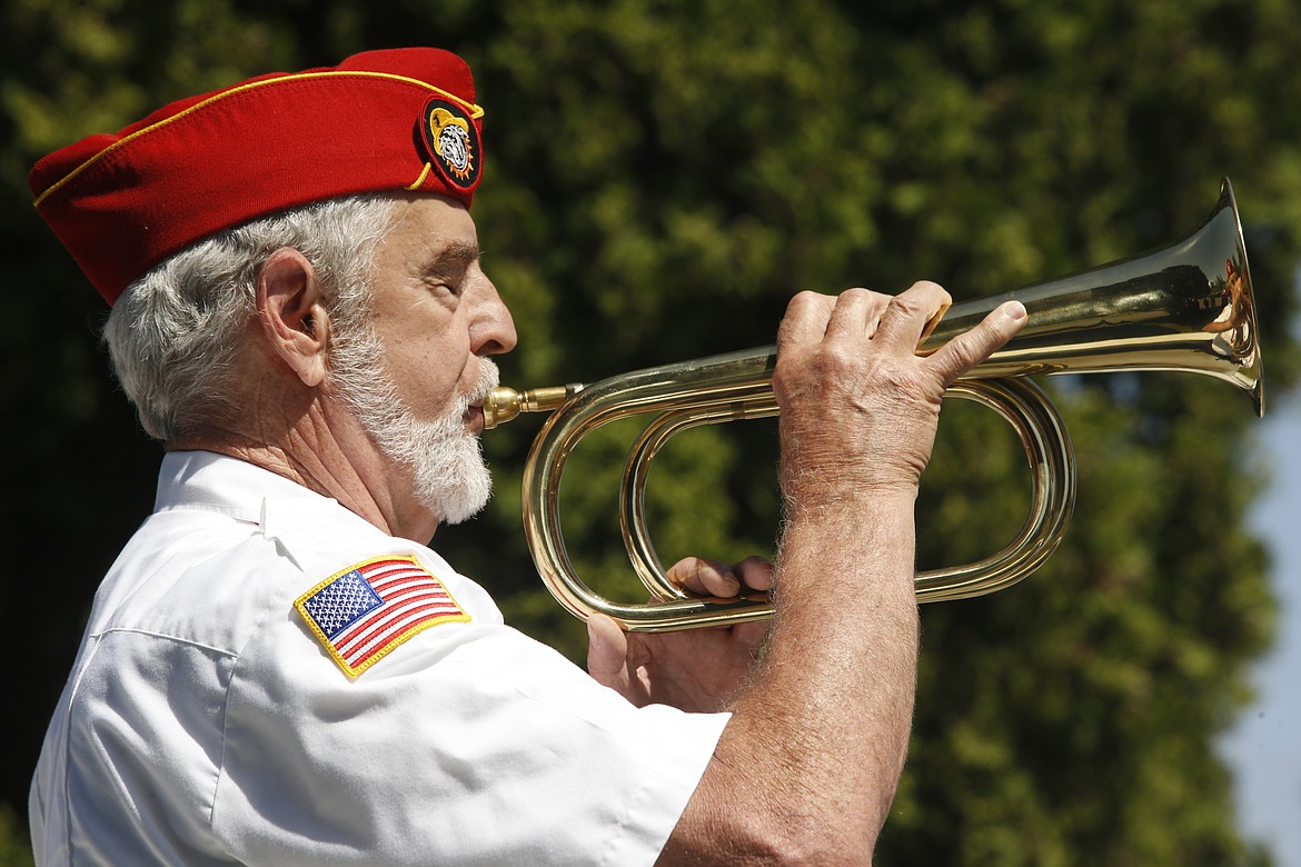 Veteran Tim McNamara plays Taps at Coeur d'Alene Memorial Gardens on Monday.