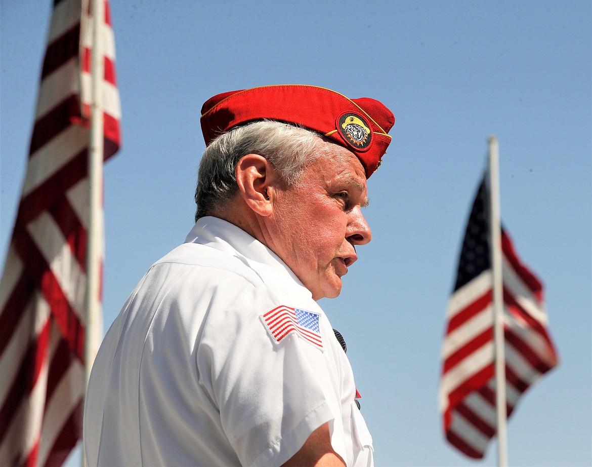 Michael Quinn, commandant of Pappy Boyington Detachment of the Marine Corps League, is framed between flags as he speaks on Monday at Coeur d'Alene Memorial Gardens.