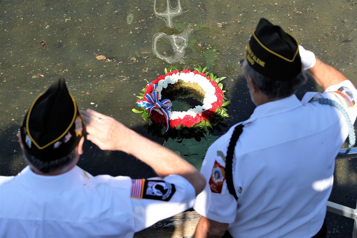 Veteran Charles Riffel, left, and VFW Post 889 Chaplain Dennis Watson salute after tossing the wreath into Lake Coeur d'Alene on Memorial Day.