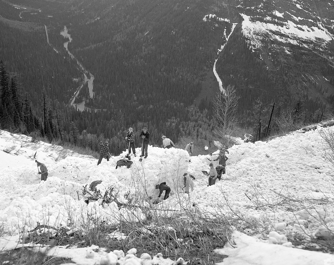 Crews use shovels to search for survivors after an avalanche killed two, severely injured another and buried survivor Jean Sullivan for eight hours in 1953. The two men on top are keeping an eye out for more slides. (Mel Ruder photo)