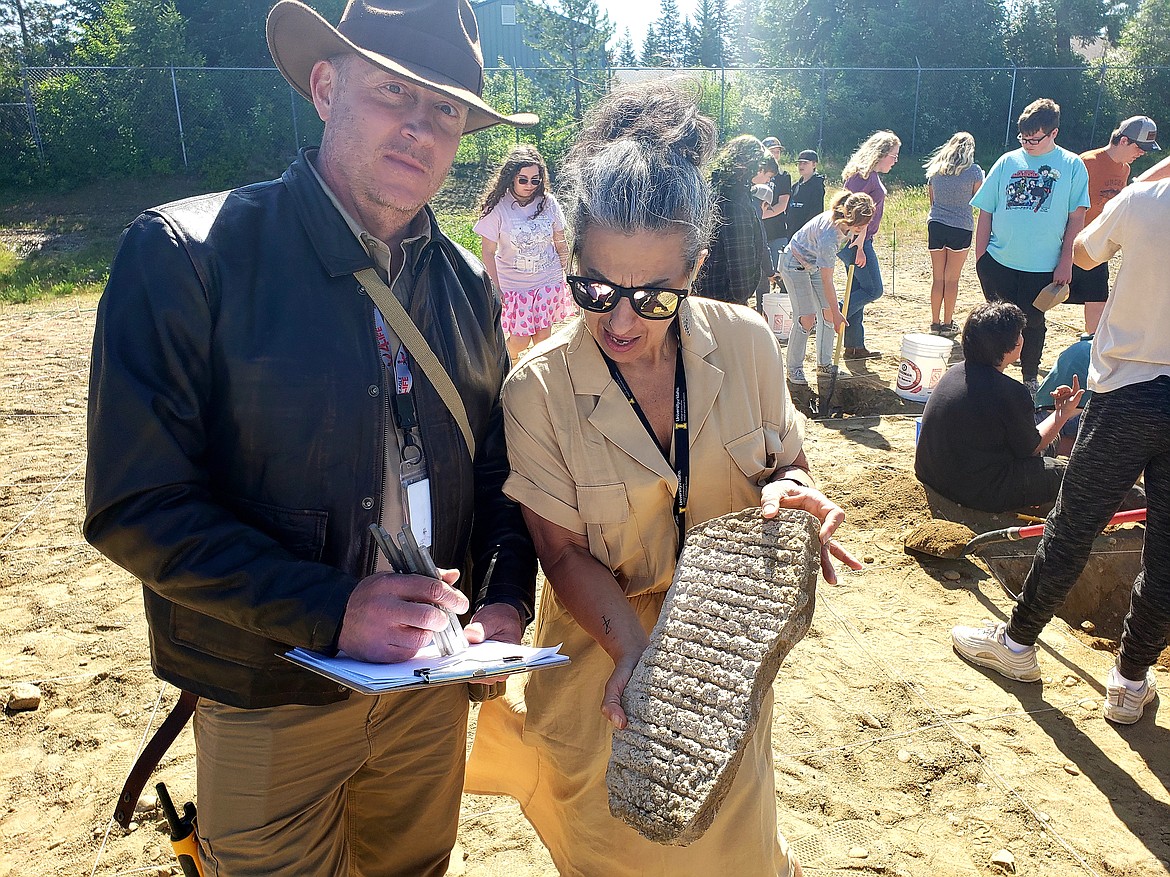 Dressed as Indiana Jones and Marion Ravenwood from "Raiders of the Lost Arc", Timberlake social studies teachers Andrew Kessner and Jennifer Emory encourage their students to find as many artifacts as they can buried in an archeological dig site on campus.