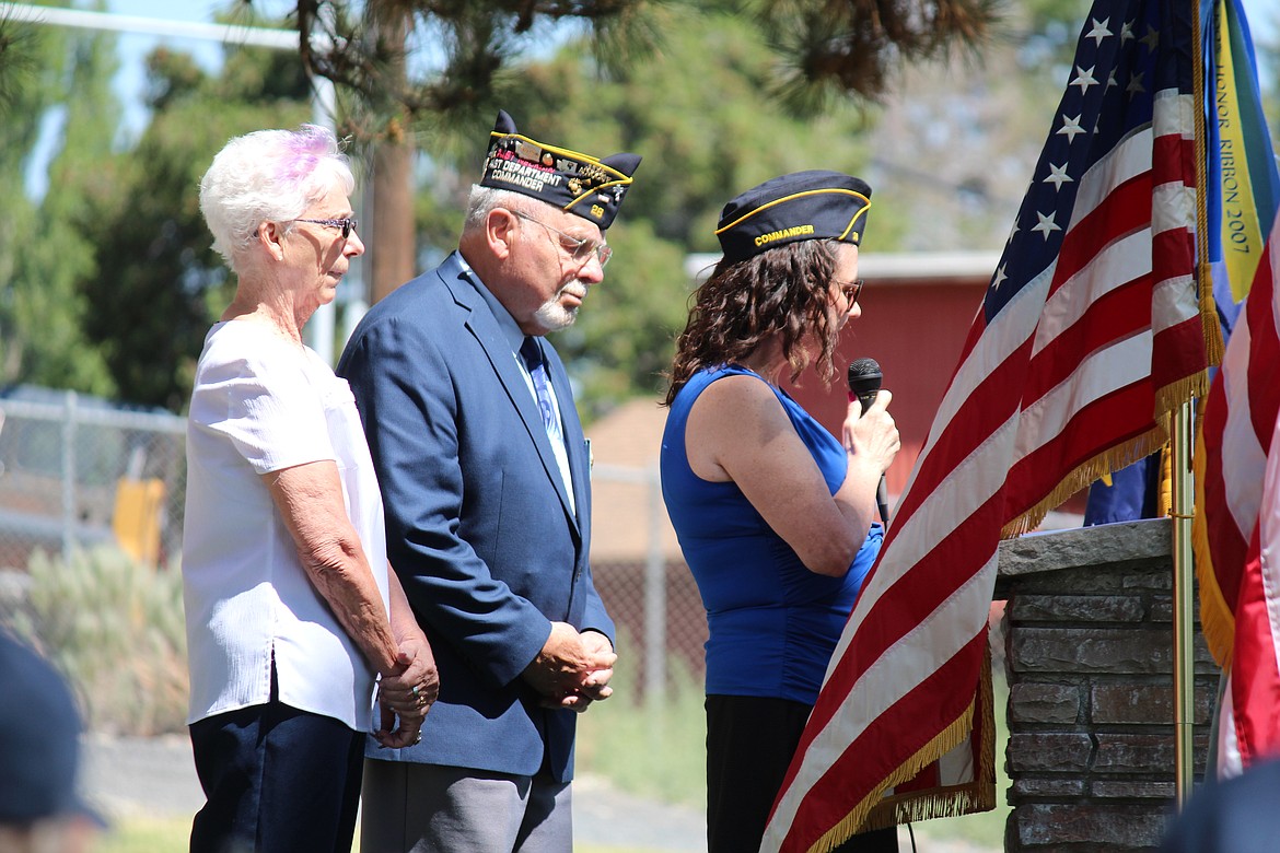 American Legion Post 28 commander Kimberly Thomas, right, reads names of veterans during a Memorial Day ceremony in Ephrata. Post 28 Auxiliary president Mardi Carroll, left, and former Post 28 commander Mike Montaney, center, listen.