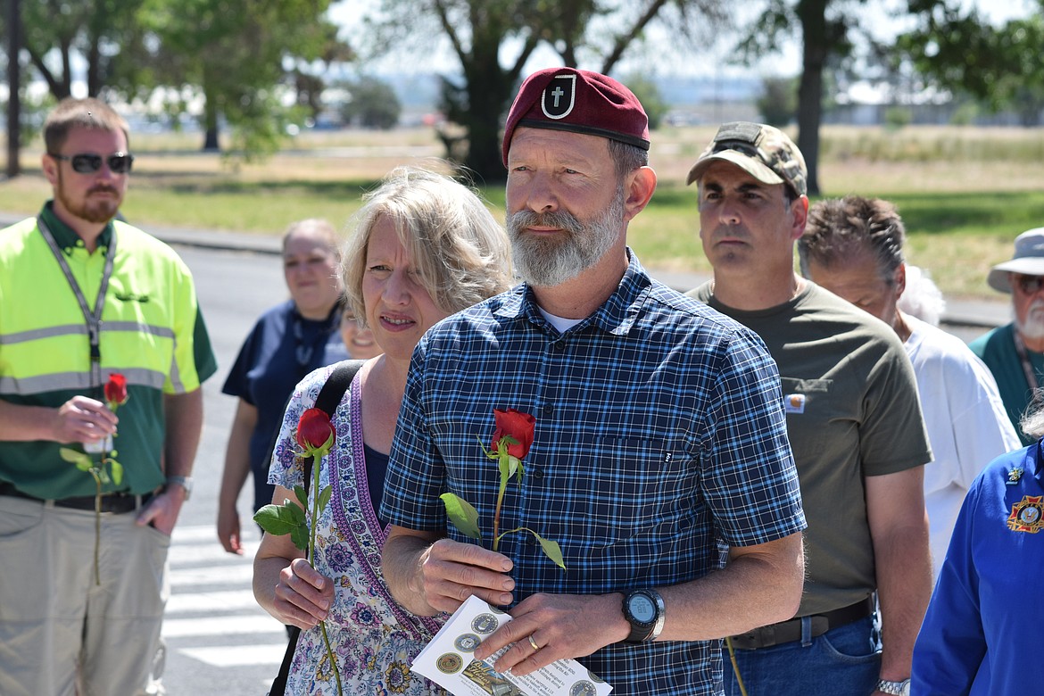 Pastor and U.S. Army veteran chaplain Mike Swartz and his wife Lesa prepare to lay roses at the memorial for 87 U.S. service members who died when their transport aircraft crashed at Larson Air Force Base on Dec. 20, 1952.