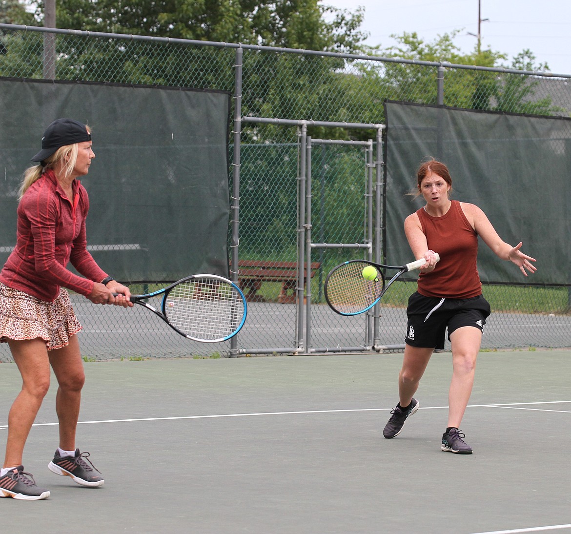 SHS tennis player Maisie Brazill gets ready to use her forehand while her partner watches in a semi-final match.