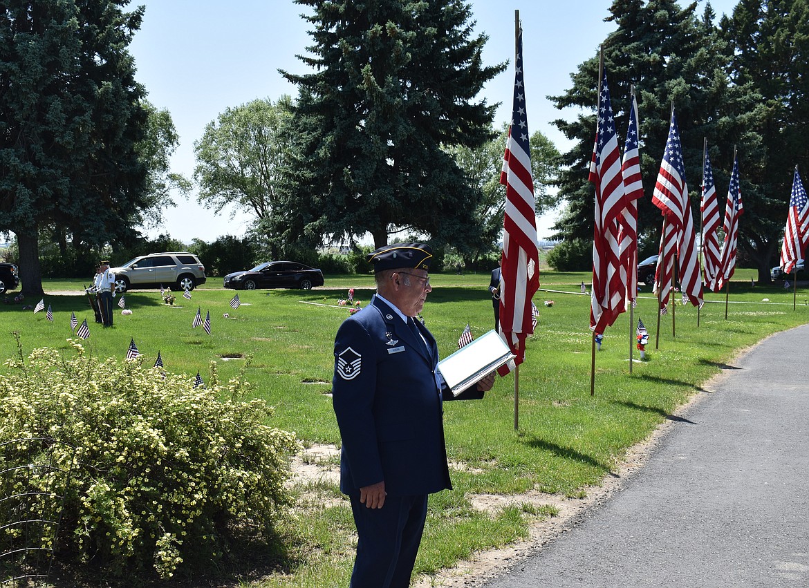 Retired Master Sgt. Fil Rivera addresses the crowd gathered for the Memorial Day ceremony at Pioneer Memorial Gardens, as the honor guard stands ready in the background to deliver the 21-gun salute.