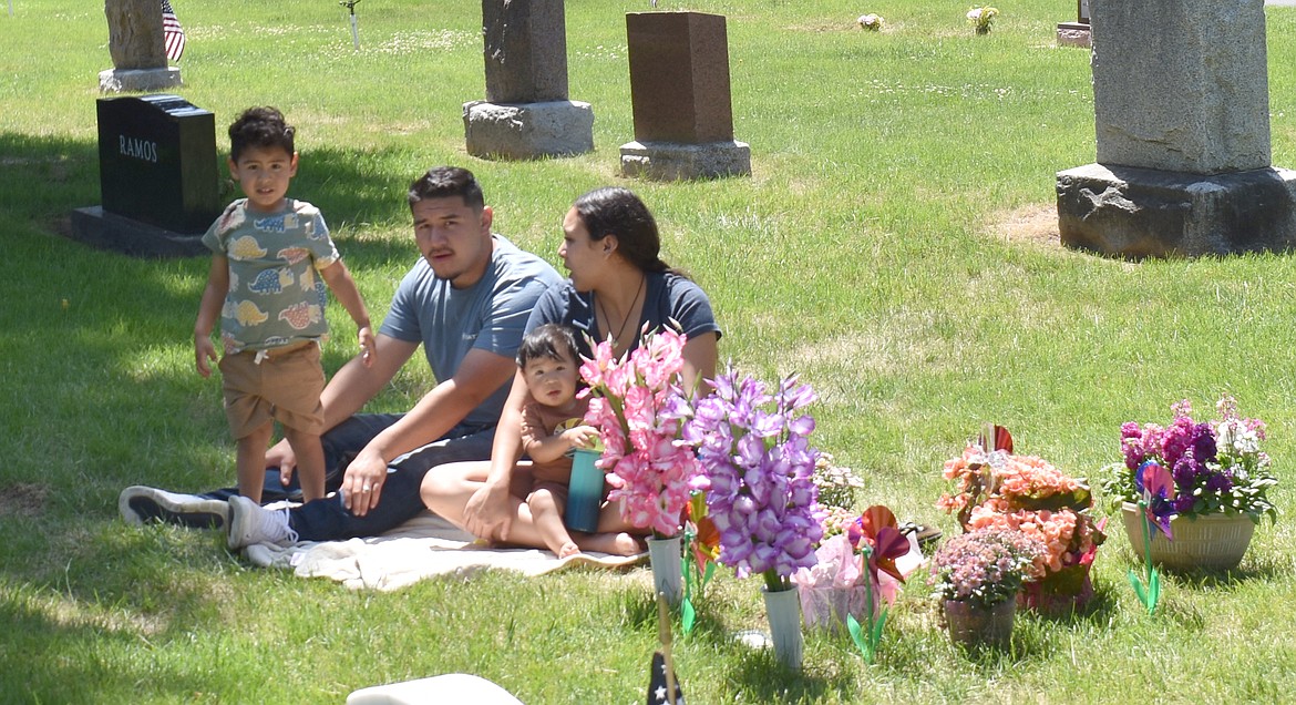 Izak Negrete, left, his wife Rosalina Johnson and their sons Izak and Marcelo Negrete pay a visit Monday to the grave of Johnson’s mother Virginia Johnson-Krupa, who passed away earlier this year.