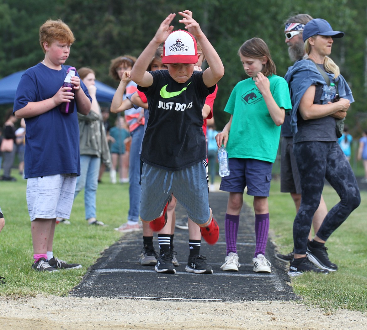 A student competes in the broad jump.