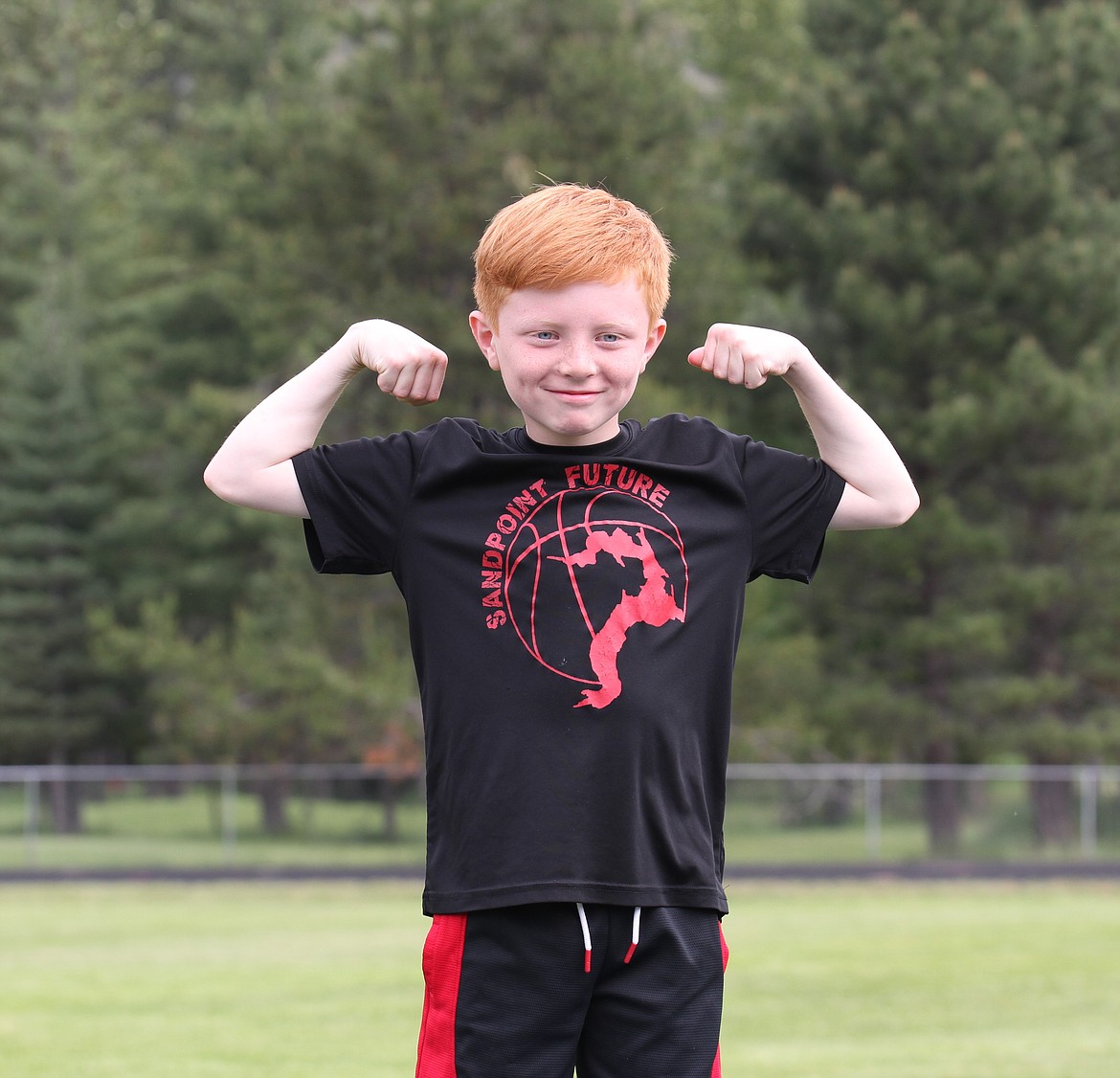A student flexes his muscles after a first-place finish.