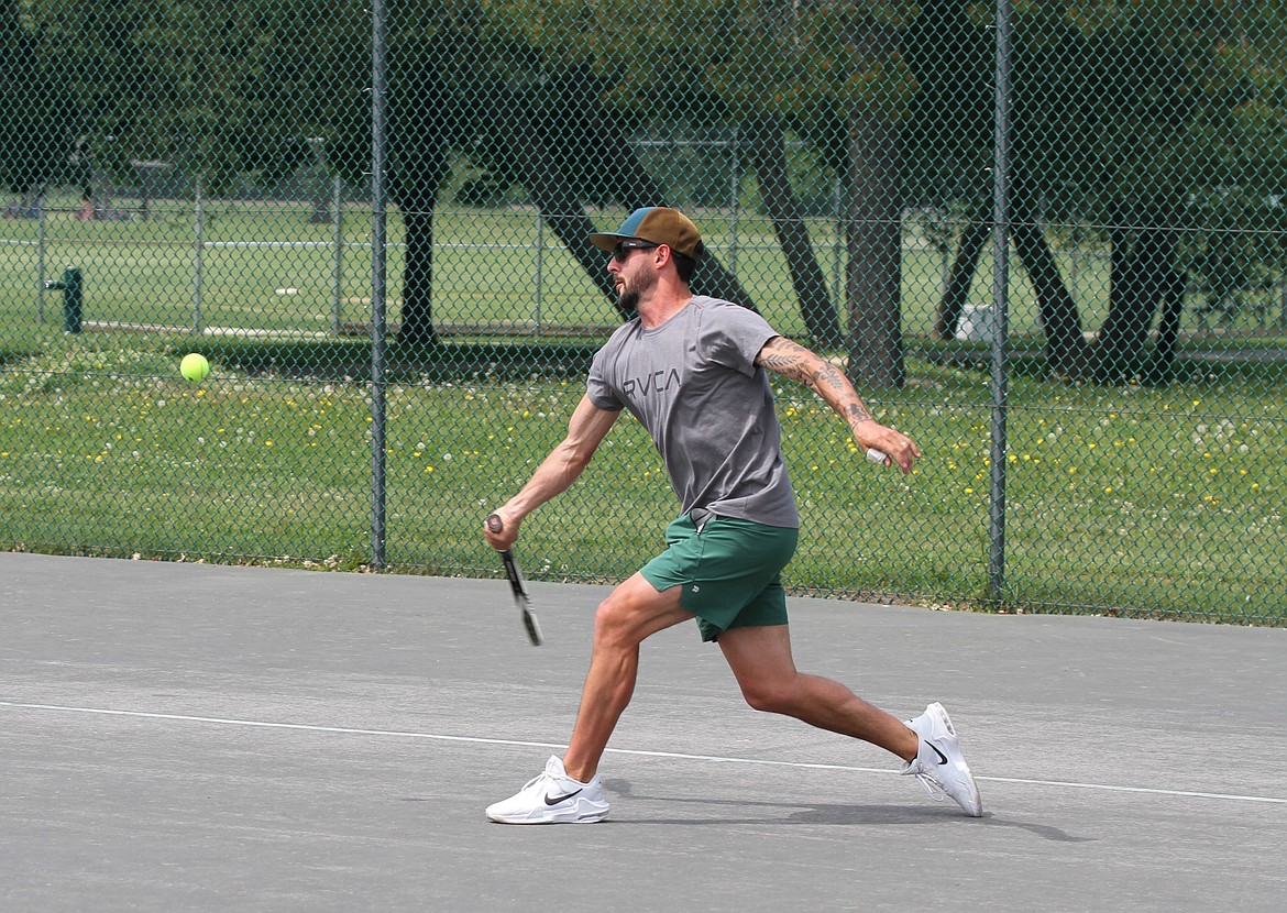 A competitor reaches out for ball in one of the tournament's draw matches.