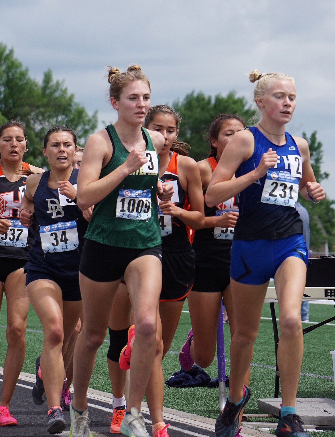 Whitefish Junior Maeve Ingelfinger (left) competes with Senior Siri Erickson from Columbia Falls in the woman’s 1600 meter run at the Class A State Track & Field Meet. Ingelfinger earned a personal best time of 5:16.76 and third position on the podium. (Matt Weller photo)