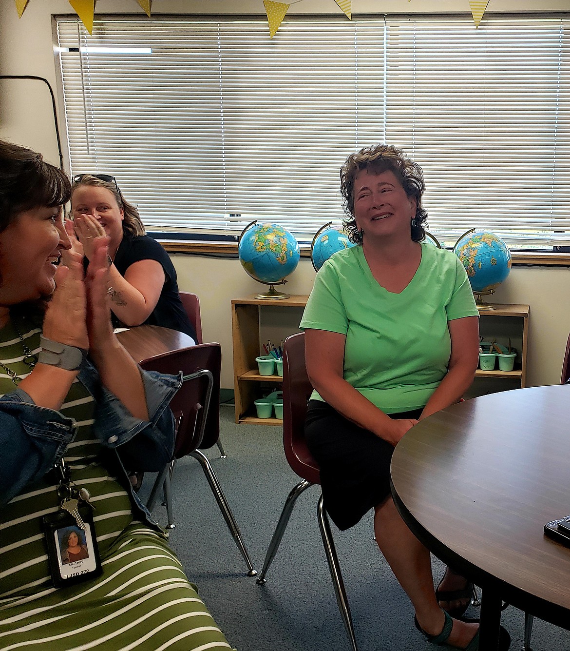 Teachers at Betty Kiefer Elementary applaud as advanced learning instructor Mary Conrath is named the teacher of the year, and awarded a $2,000 travel voucher.