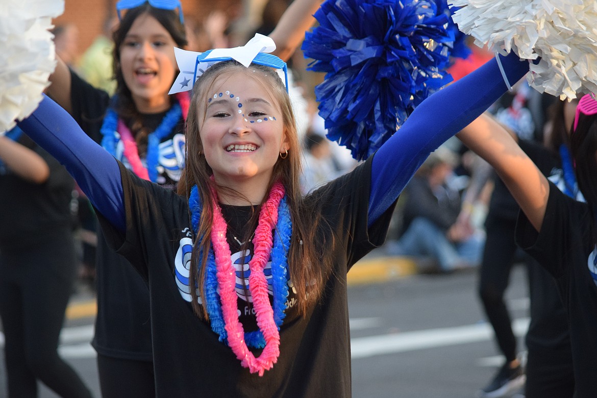 A Frontier Middle School student shows off school spirit as she marches in the Grand Moonlight Parade down Third Avenue on Saturday.