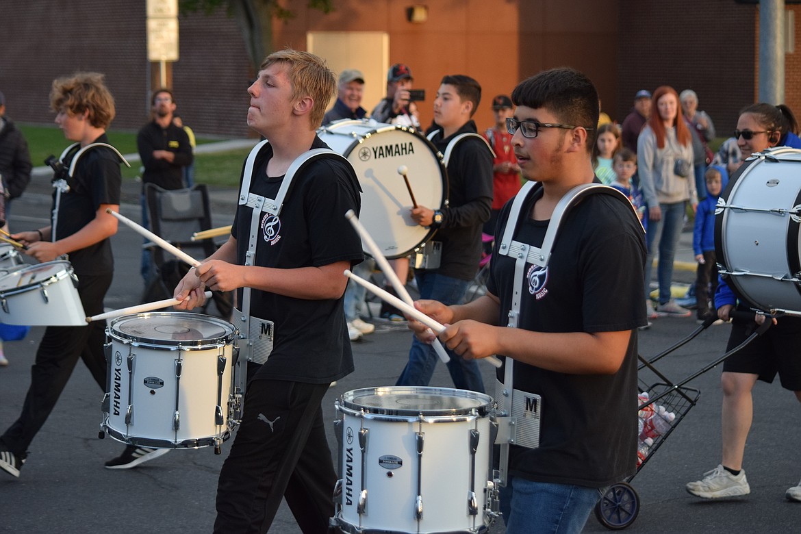 Drummers from Frontier Middle School keep the rhythm for the school’s marching band during the Grand Moonlight Parade on Saturday.