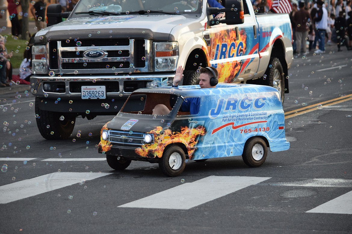 A tiny truck with Just Right Cleaning and Construction makes its way down Third Avenue during the Grant Moonlight Parade on Saturday.