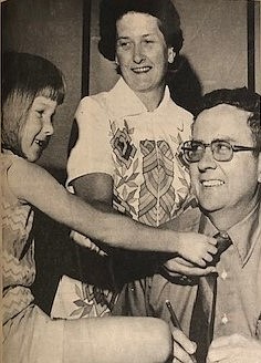 In the early 1970s, daughter Carolyn and wife Mary Ann help remove Mayor John McHugh's tie.