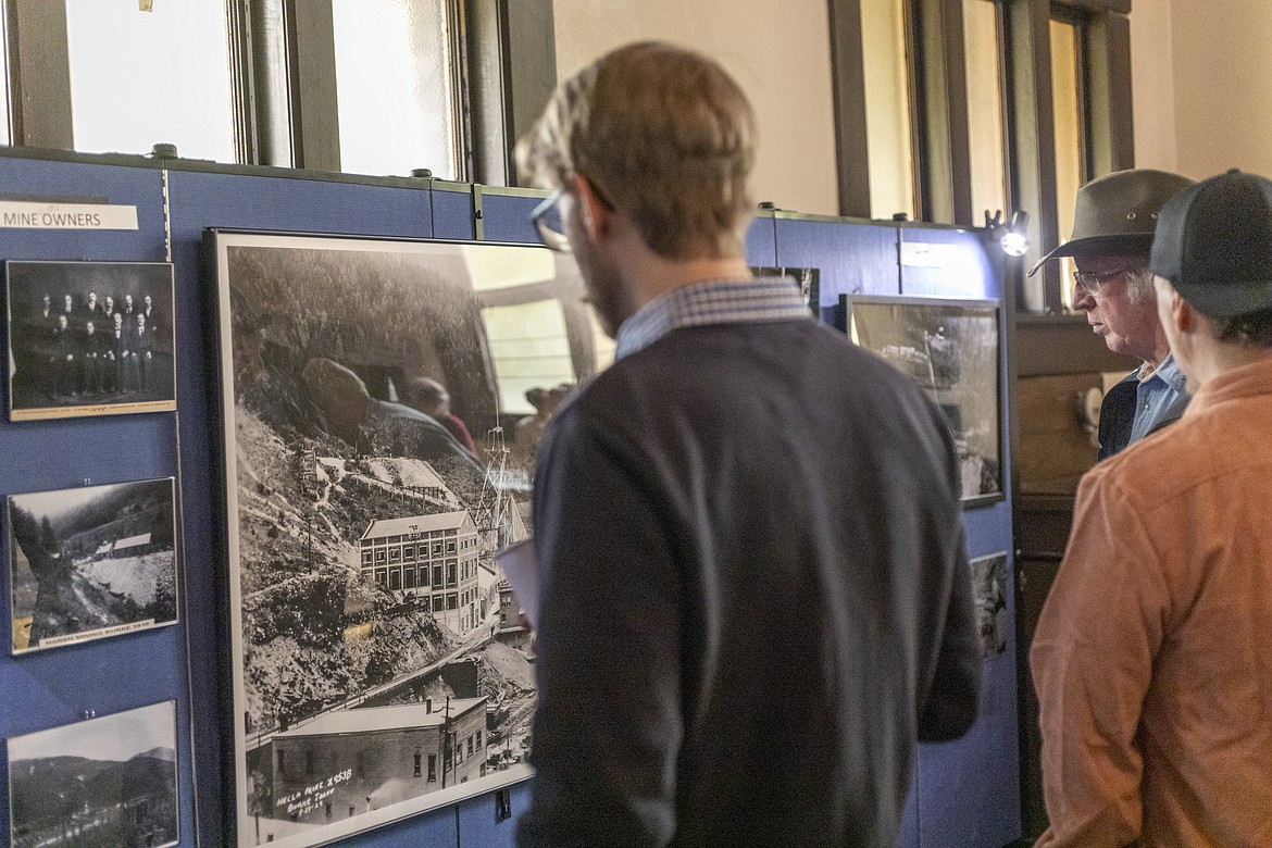 Wallace resident Charlie Roberts examines an aerial photo of the Hecla Mine in Burke, Idaho, during the Barnard-Stockbridge Museum's Spring Fling gala.