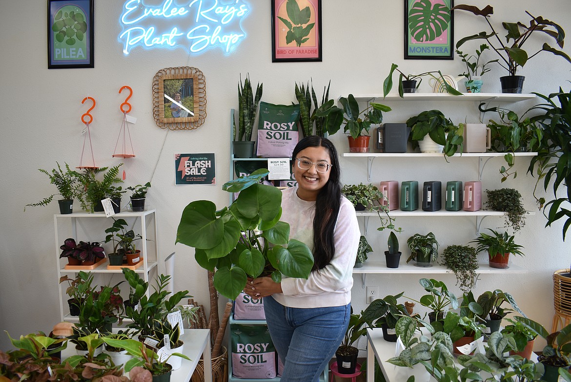 Breanna Verduzco, owner of  Evalee Ray’s Plant Shop in Moses Lake, holds up a monstera. These plants grow pretty large, as the name suggests, but they’re very beginner-friendly, she said.