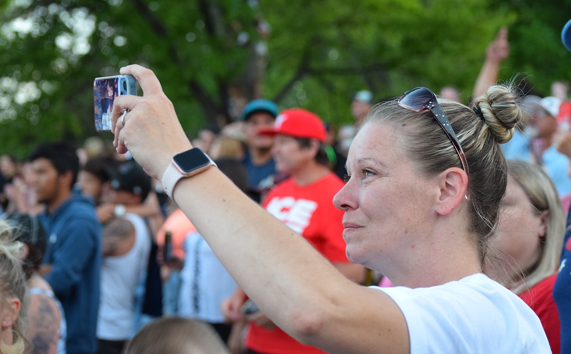 A member of the audience streams some of Vanilla Ice’s set during his Sunday performance. Much of the crowd was also invited onstage to dance with the performer, his DJ and Michaelangelo.