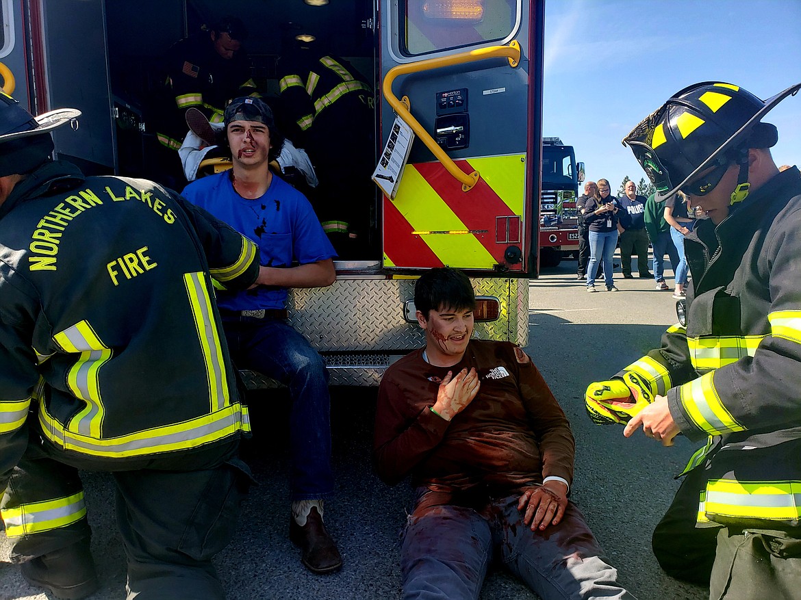 Lakeland High School seniors Trey South, left, and Taylor Winkelkotter receive "medical attention" Friday morning during a mock DUI scene staged by students and first responders. The event this year focused on fentanyl use.