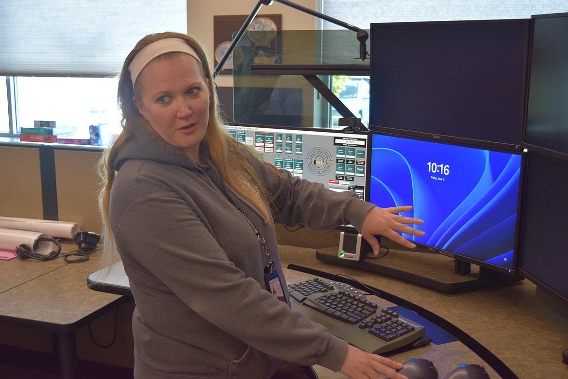 Grant County Multi-Agency Communications Center Operations Supervisor Amanda Scott shows off a 911 operator’s workstation, which integrates both incoming 911 emergency phone calls and all first-responder radio frequencies. The agency has 16 full-time 911 operators and eight 911 workstations, of which four will be staffed during an ordinary shift, Scott said.