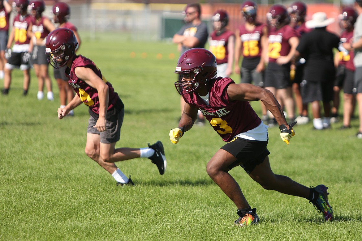 Moses Lake junior Joel Middleton, right, gets off the line of scrimmage during a goal line session of a Maverick practice.