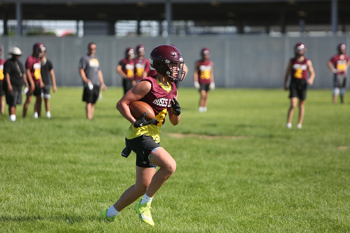 Moses Lake sophomore Carson Huberdeau runs with the football during a Maverick spring practice on Tuesday.