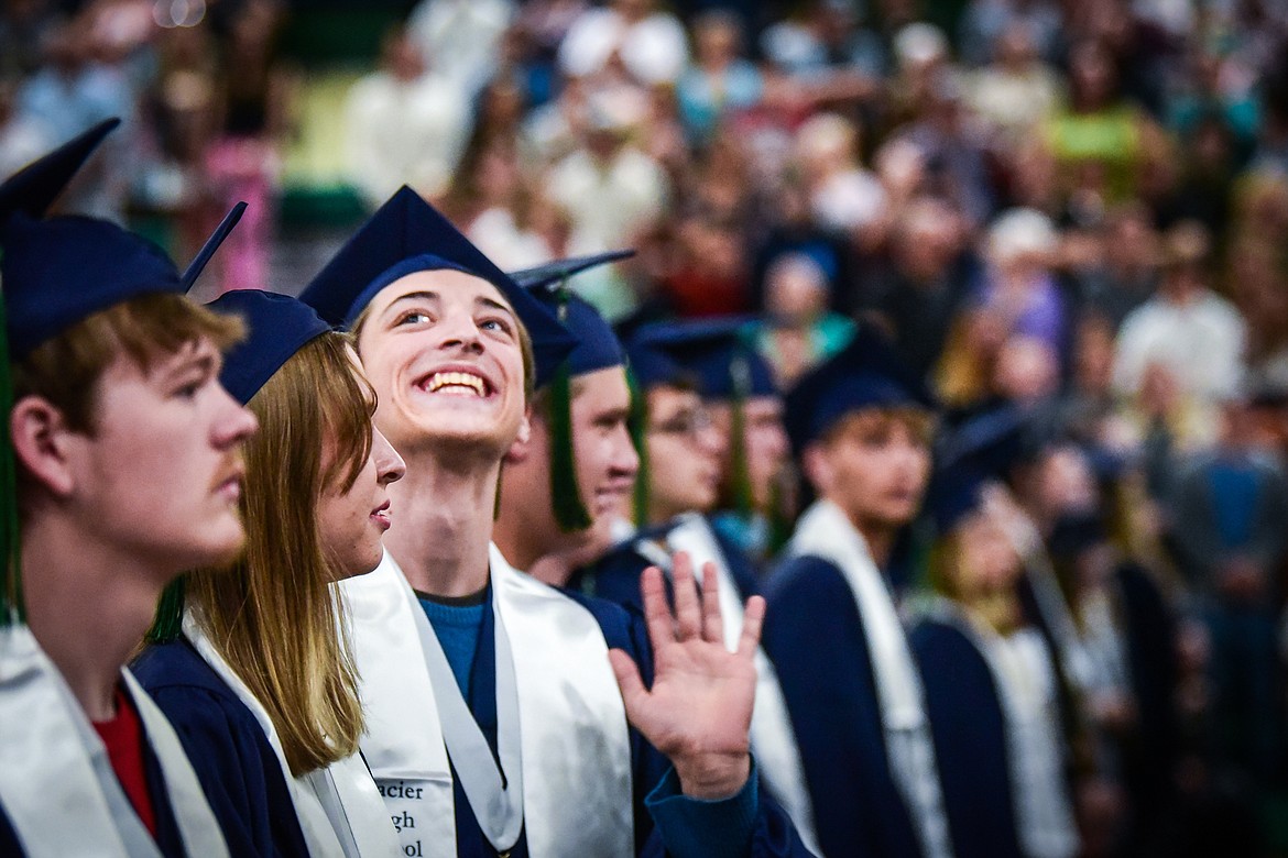 A graduate waves to the crowd during Glacier High School's commencement ceremony on Saturday, June 3. (Casey Kreider/Daily Inter Lake)