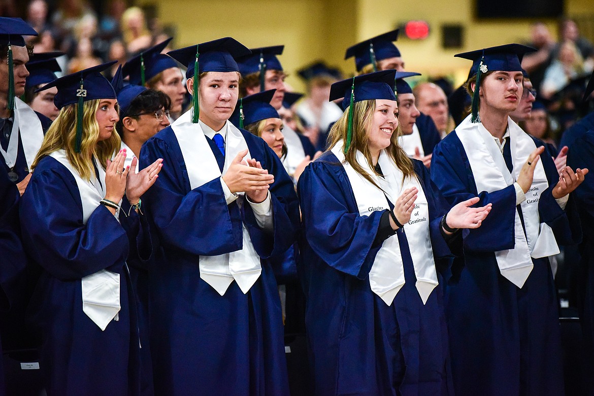 Graduates clap after the national anthem, sung classmate Kaid Buls, during Glacier High School's commencement ceremony on Saturday, June 3. (Casey Kreider/Daily Inter Lake)