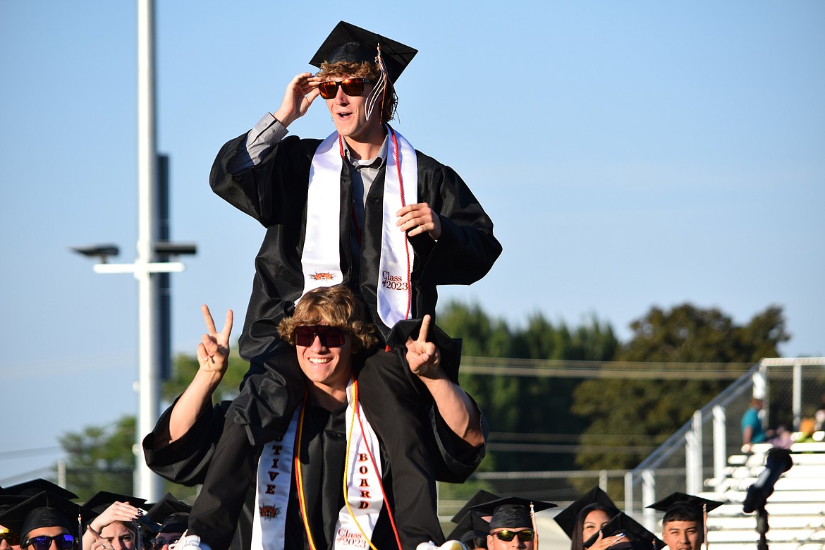 A pair of graduating seniors with the Ephrata High School class of 2023 celebrate during the processional at the start of the school’s graduation ceremony on Friday.