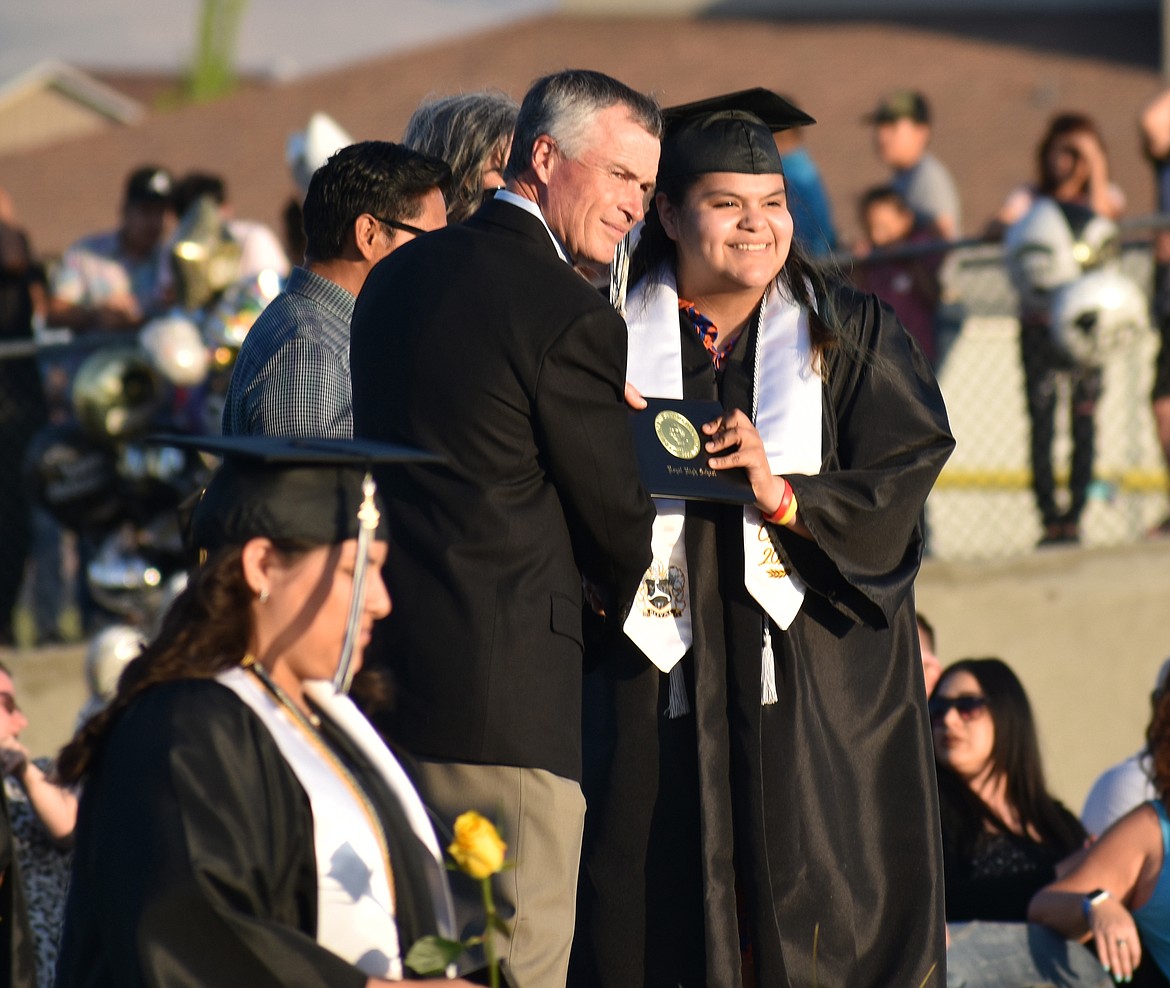 A Royal High School senior received her diploma from School Board President Craig Janette, left, on Friday.