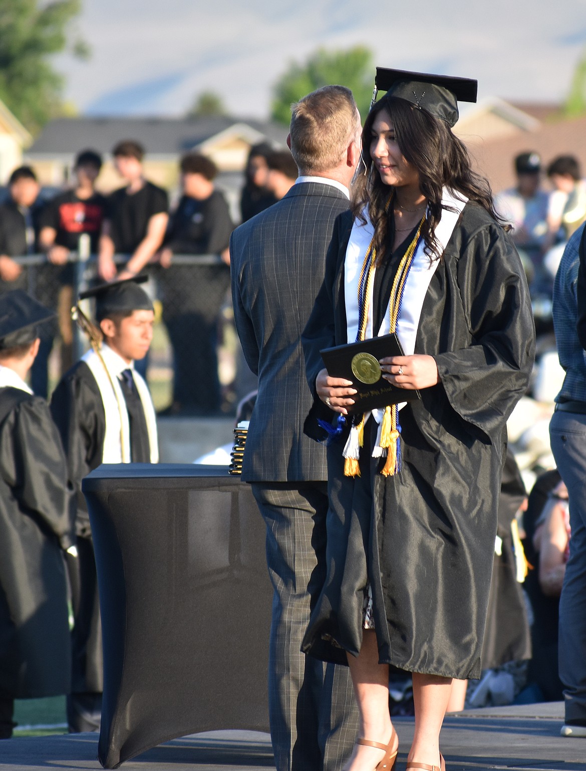 A Royal High School senior looks a little in awe as she steps down from the stage with her high school diploma.